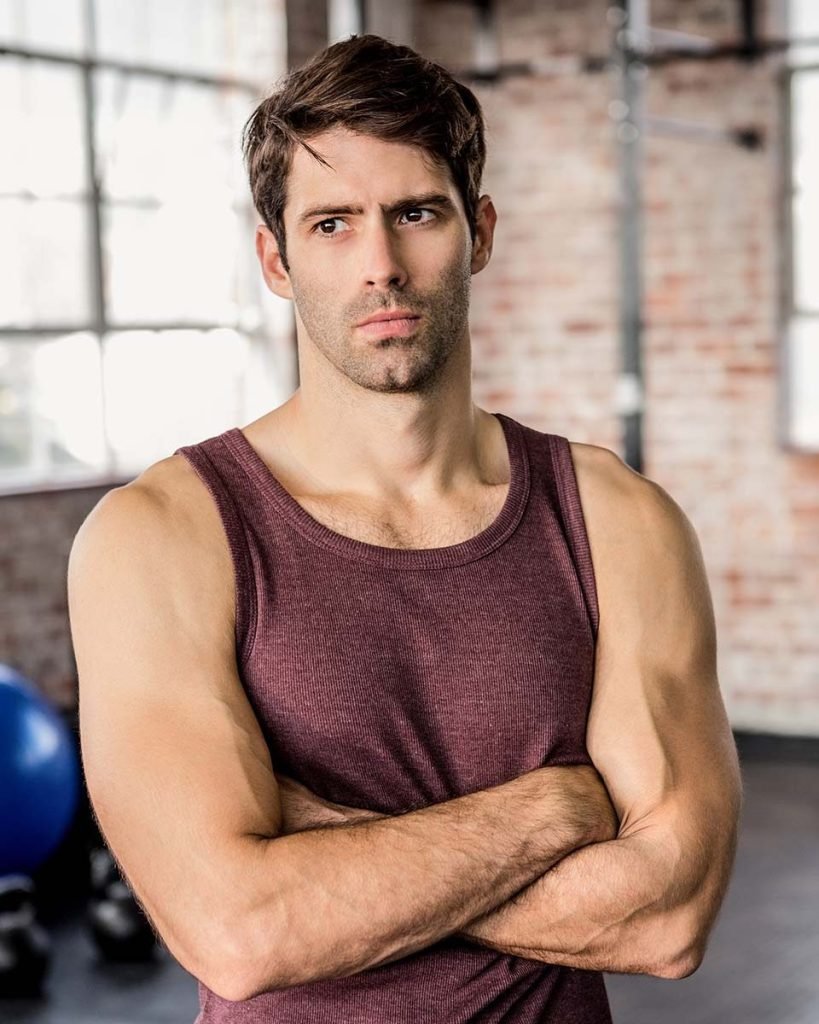 portrait of a serious man with arms crossed at the P2RW7VR.jpg