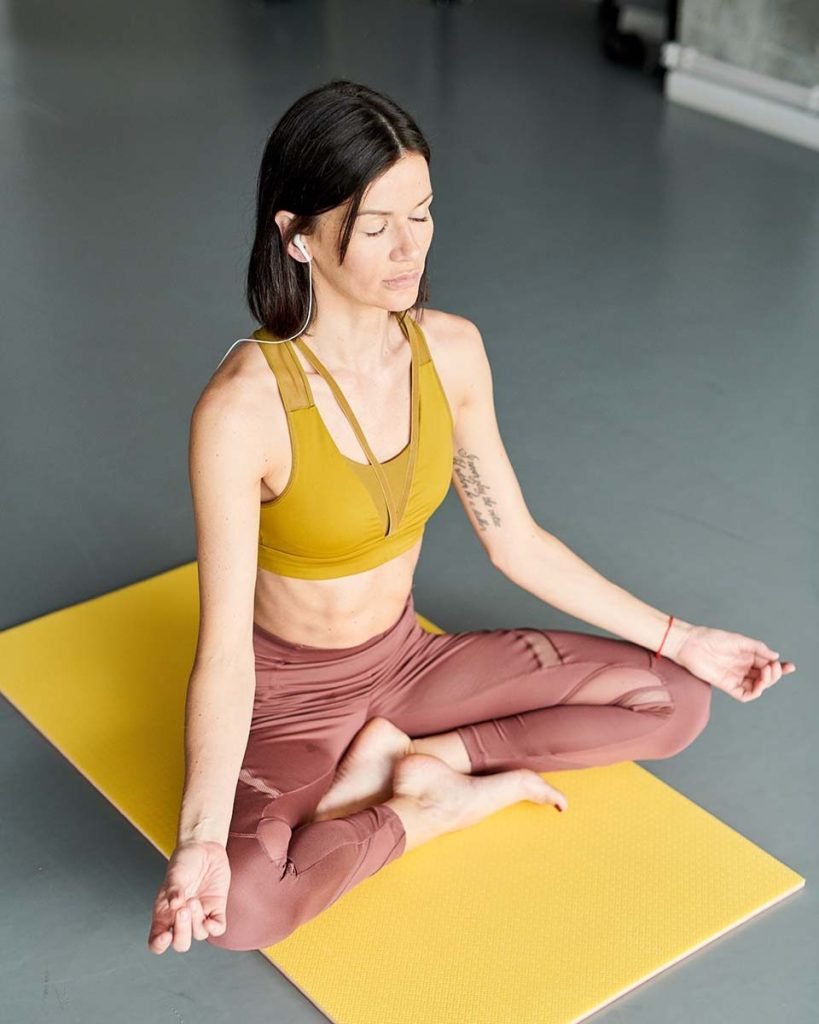 young woman meditating in gym QGFPS6X.jpg